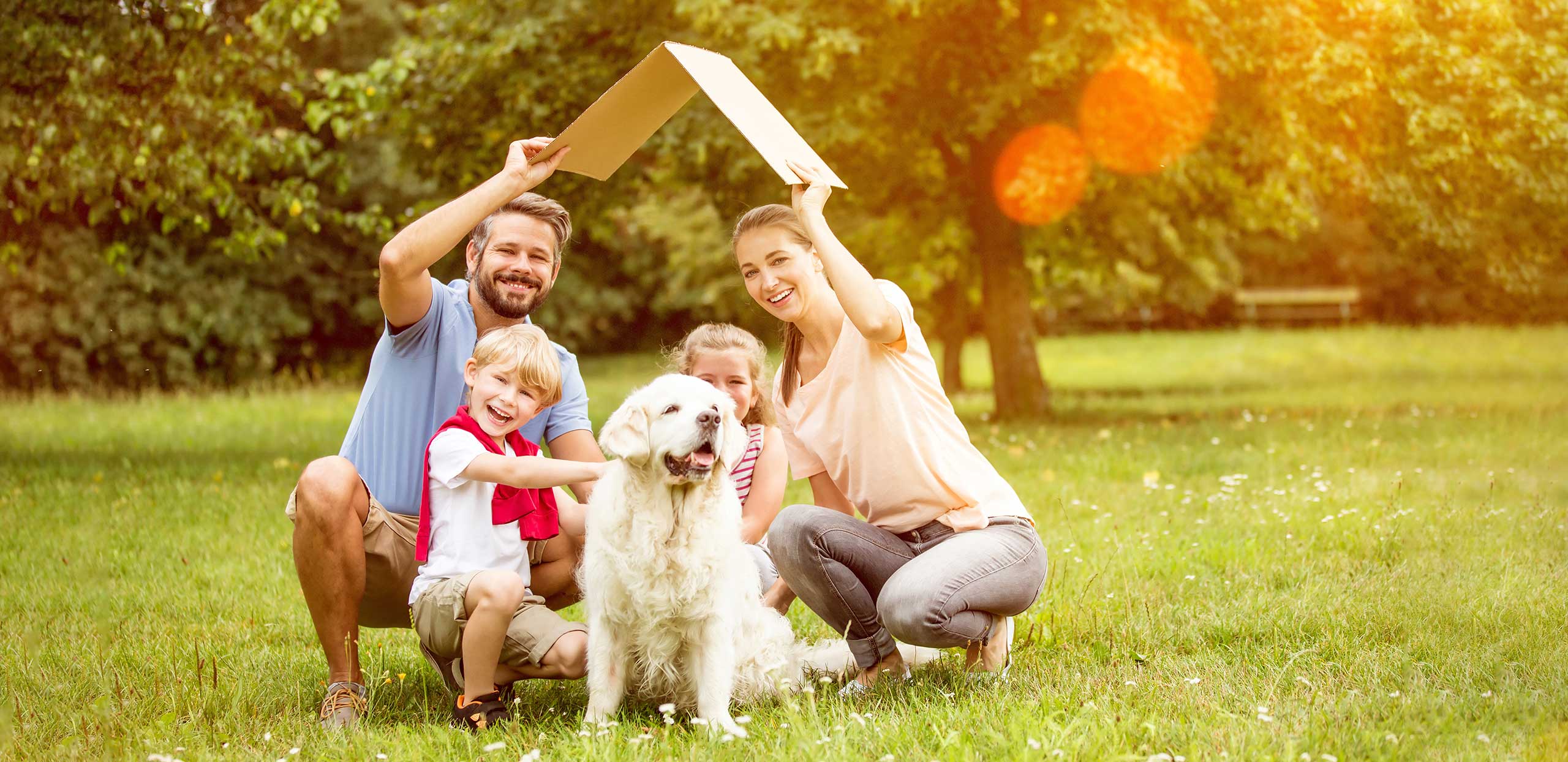 Family holding a cardboard roof overhead